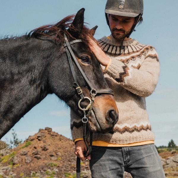 close up of a man with an Icelandic horse