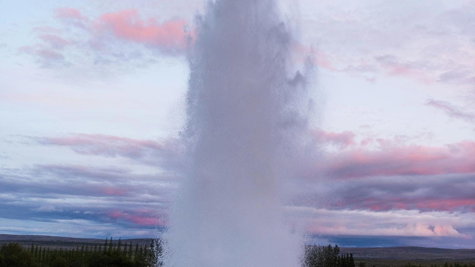 Geysir erupting on a summer evening in the Golden Circle