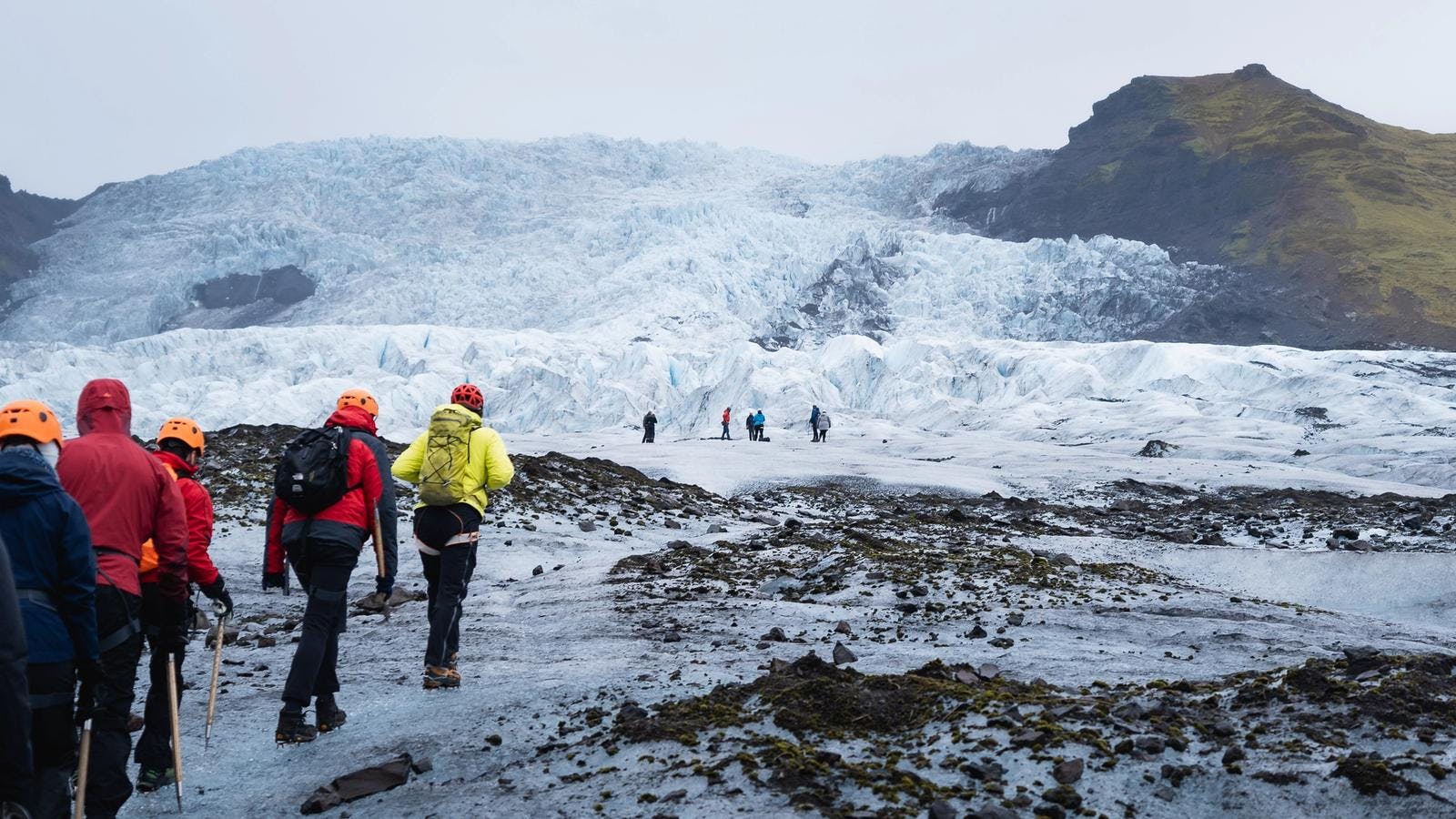 glacier hike tour setting off to vatnajokull glacier in colourful windbrekars on a sunny day